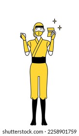 A woman dressed up as a ninja who is pleased to see a bankbook.