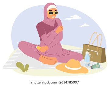 A woman dressed in a stylish outfit sits comfortably on a blanket outdoors, wearing sunglasses