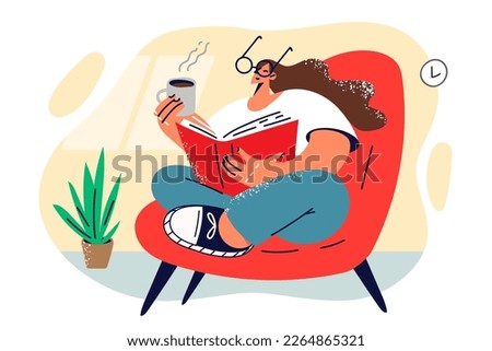 Woman is drinking coffee and reading interesting book or professional literature enjoying rest after hard day work. Woman with photo book sits in cozy armchair and drinks hot tea nostalgic for past