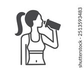 Woman drinking water after workout. Silhouette of a sporty woman in a sports bra drinking water from a bottle after her workout.