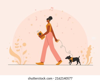 Woman with earphones walking and listening to a music online.  Afro woman with earphones listening to a music online. Promo banner for Podcast, Streaming, Online show, blogging, radio broadcasting. he
