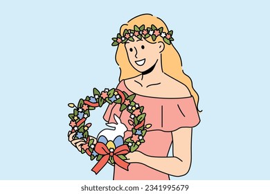 Woman with easter wreath on head smiles and holds colored eggs and miniature rabbit. Girl dressed in pink dress with easter accessories inviting to celebrate religious christian holiday