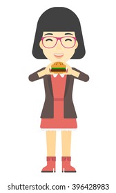 Woman eating hamburger. 