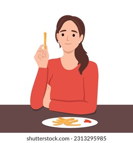 Woman eats french fries without thinking about health risks of fast food and fried snacks. Girl is having lunch in cafe sitting at table with french fries and needs consultation with nutritionist.