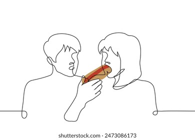 woman eats a hotdog, the other watches him - one line art vector. gourmet concept, hungry satisfies hunger with fast food, envy someone else's metabolism. Handmade vector not AI