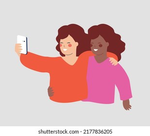 Woman embraces her best friend and taking selfie. Women hug each other and hold a smartphone for texting, listing to music or chatting online. Concept of mobile usability, friendship and technology.