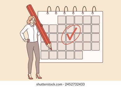 Woman is engaged in business planning and uses calendar to keep schedule, standing with large pencil in hand. Businesswoman making planning to increase productivity and avoid missing deadlines