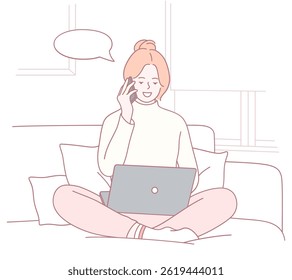Uma mulher que se envolve em trabalho remoto enquanto está confortavelmente sentada, multitarefa eficiente com seu notebook e telefone
