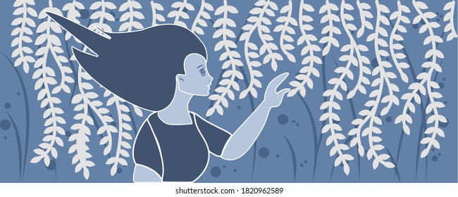 Woman European appearance with long dark hair is walking along the hanging branches in blue colors. The person is turned in profile and touches with her hand the plant, which is swaying in the wind.