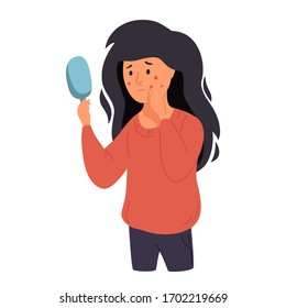 A woman examines her face in a mirror. Acne, skin problems and acne. Sad girl discontent with herself