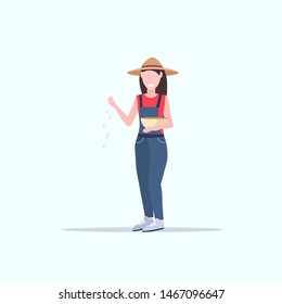woman farmer feeding chickens poultry breeding farming agriculture concept girl in hat and robe holding tray with wheat flat full length