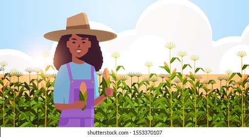 woman farmer holding corn cob african american countrywoman in overalls standing on corn field organic agriculture farming harvesting season concept flat portrait horizontal vector illustration