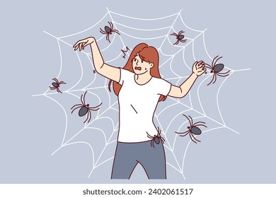 Woman with fear of spiders is terrified of being entangled in cobweb and needs treatment for arachnophobia. Girl with arachnophobia screams in fear imagining that she has become victim of insects