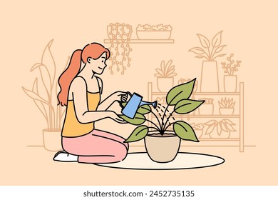 Woman florist grows houseplants to decorate own apartment, waters flower sitting on floor. Girl breeds houseplants, being interested in botany and enjoying presence of homemade flowers in house