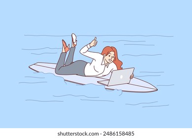 Woman freelancer rides surfboard on sea and works with laptop, showing thumbs up. Busy girl freelancer in casual clothes jobs during vacation due to lack of time management skills.