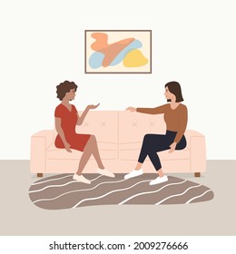 Woman friends sitting at sofa and talking Friends relaxing at home People spending time together