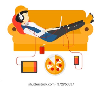 Woman with gadgets lying on sofa.