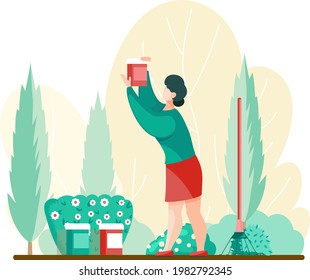 Woman gardener and farmer works in garden, takes care of yard. Female gardening, agricultural worker growing plants and flowers on lawn or backyard. Horticulture, organic garden, gardening hobby