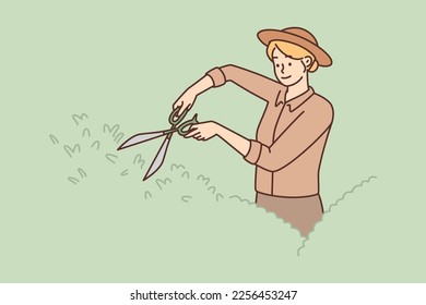 Woman gardener uses large scissors to shape bushes and remove diseased twigs. Girl working as gardener takes care of garden plants doing and decorating landscaping