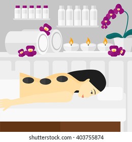 Woman getting stone therapy.