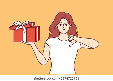 Woman with gift in hands is nervous and points finger down due to poor quality of present. Girl is holding gift tied with ribbon and is embarrassed, feeling offended because of unacceptable surprise.