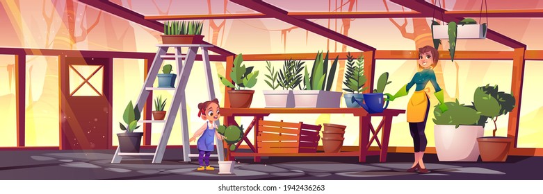 Woman and girl care plants in glass greenhouse