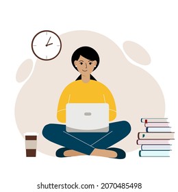 A woman or a girl sits and works at a laptop. Remote work or communication over the Internet. Satisfied, joyful.