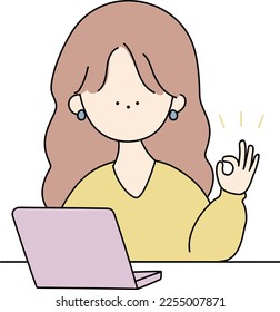 A woman giving an ok sign in front of a computer