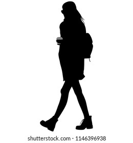 woman in glasses with a backpack and a cup of coffee in her hand is going