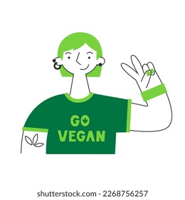 Woman in go vegan shirt. Vegetarian and plant-based healthy diet concept. Sustainable, cruelty-free, climate-friendly, meatless and dairy-free food. Meat and animal protein replacement.