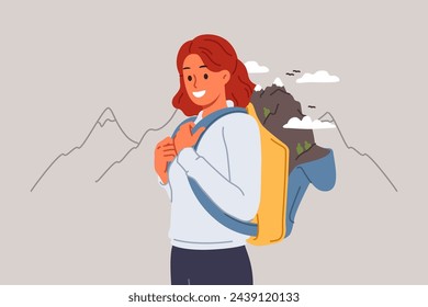 Woman goes hiking in mountains, posing in outdoor clothing with backpack for personal belongings. Girl loves hiking and traveling through national parks looks at screen with smile.