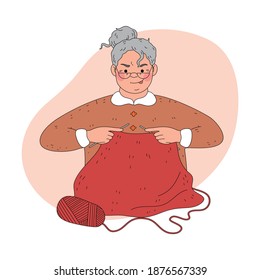 Woman grandmother in glasses sitting and knitting warm sweater from red wool