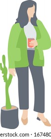 the woman in the green jacket is enjoying a cup of coffee