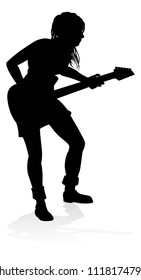 A woman guitarist musician in detailed silhouette playing her guitar musical instrument.