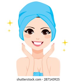 Woman with hair wrapped in blue bath towel showing perfect facial skin