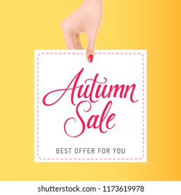 Woman hand holding card with autumn sale lettering. Autumn offer or sale advertising design. Handwritten text, calligraphy. For leaflets, brochures, invitations, posters or banners.
