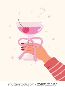 Woman hand holding a cocktail Glasses with Bow style, Happy celebrating birthday party, Hand with champagne for celebration. 