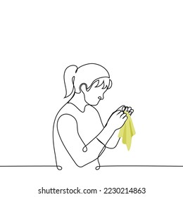 woman with handkerchief sewing up handkerchief - one line drawing vector. concept seamstress