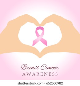 Woman hands holding pink breast cancer awareness ribbon