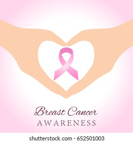 Woman hands holding pink breast cancer awareness ribbon
