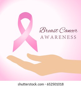 Woman hands holding pink breast cancer awareness ribbon