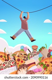 woman hanging rope above junk food assortment of fast food unhealthy nutrition junkfood addiction concept
