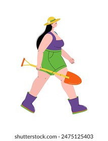 Woman in a hat. A woman carries a shovel in her hands.Garden.