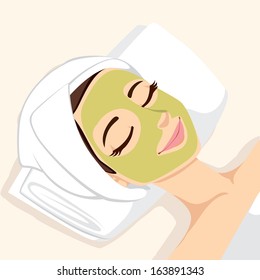 Woman having acne treatment with natural facial green mask to clean face skin