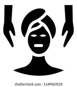 
Woman head wrapped in towel taking facial massage from two hands on sides 
