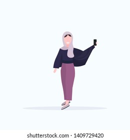 woman in headscarf taking selfie photo on smartphone camera arab female cartoon character posing white background flat full length