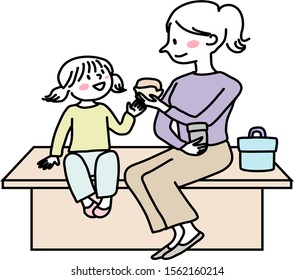 Woman and her kid sitting together on bench, have lunch. Mother and little daughter sitting on bench and eating sandwiches. Cute mother and little child eating food together outdoors. 