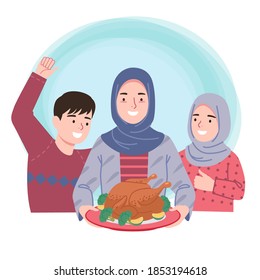 A woman in a hijab holding a plate containing a roast chicken, and her children laugh happily