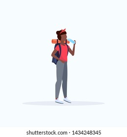 woman hiker with backpack drinking water african american girl traveler on hike hiking concept full length flat white background