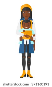 Woman holding baby in sling.